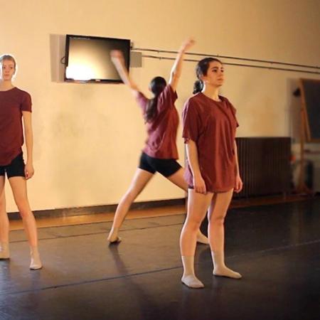 three women dancers rehearsing and a man photographing them